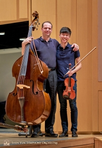 Principal Bassist Juraj Kukan and violinist Austin Zhong happily pose for the camera.